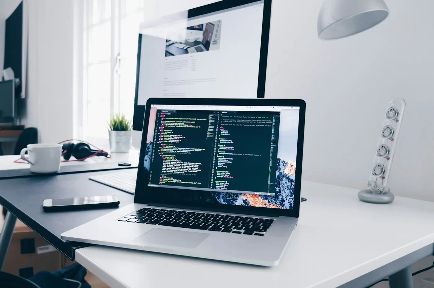 A laptop showing code on a bright desk