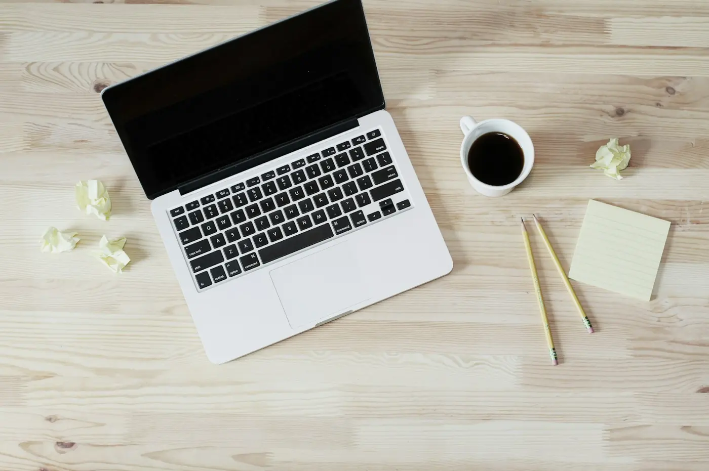A laptop and a cup of coffee on a desk